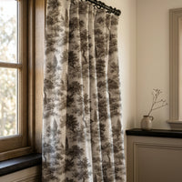Grey landscape toile curtains in a warm living room