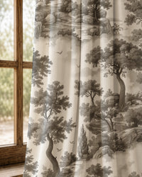 Pair of grey landscape toile curtains at an arched window