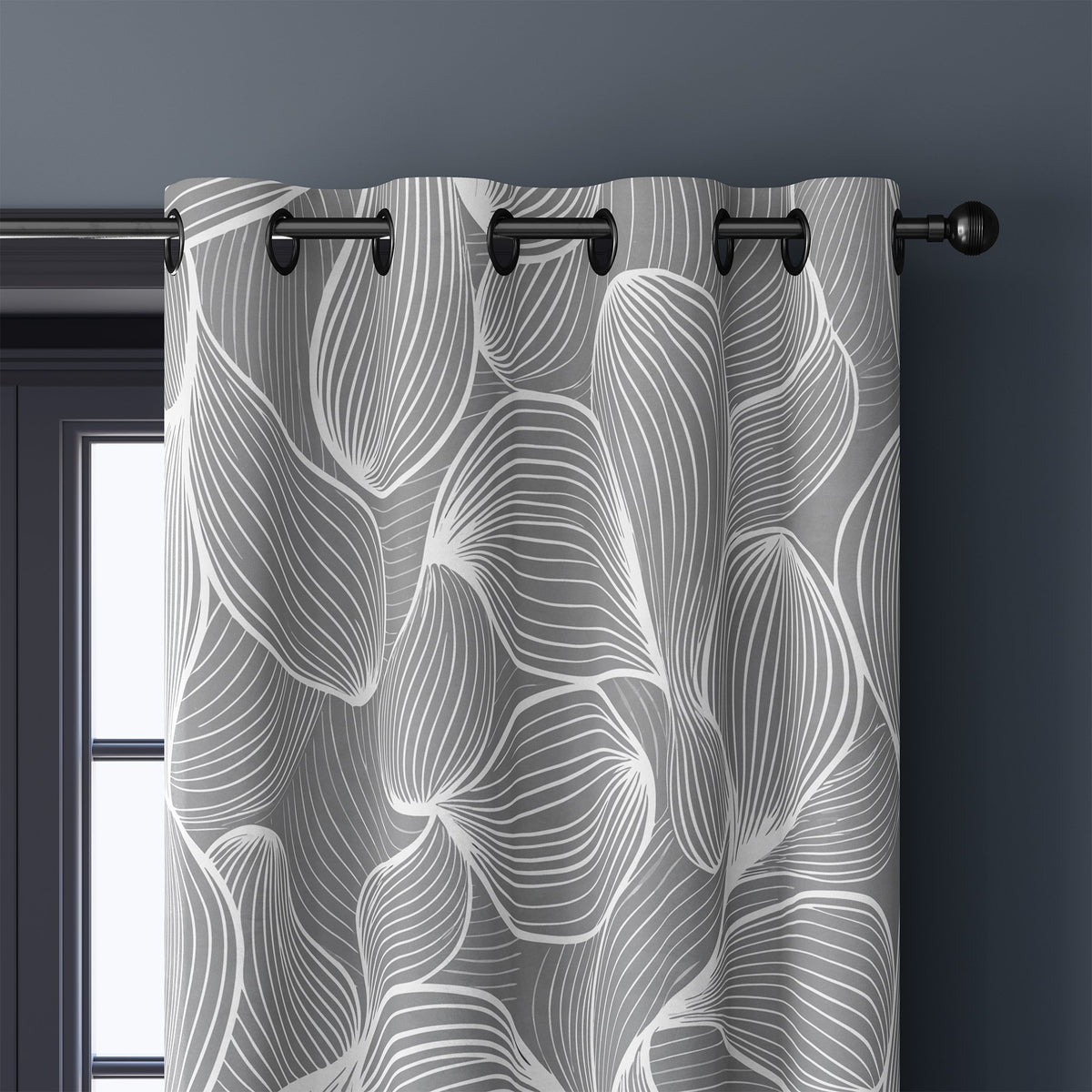 Close-up of grey line art leaf curtain grommets on a black rod