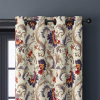 Close-up of jacobean floral curtain grommets on a black rod