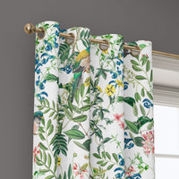 Grommet top of a jungle botanical floral curtain on a brass rod