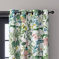 Close-up of jungle botanical floral curtain grommets on a black rod
