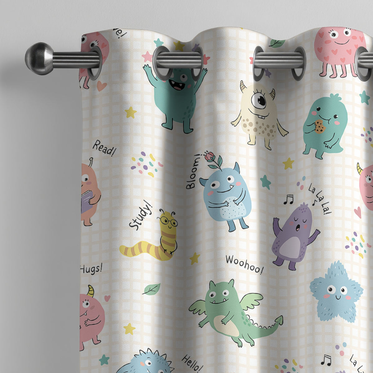Little monsters kids curtain on a grommet rod, close-up of the print