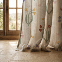 Hem of a minimal tulip stem curtain resting on a stone floor
