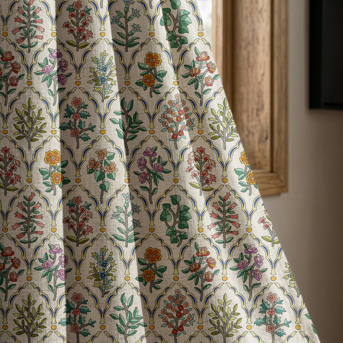 Mughal flower block print curtain panel beside a rustic wooden window