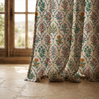Hem of a mughal flower block print curtain resting on a stone floor