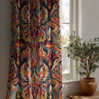 Multicolor ikat curtain beside a potted olive tree