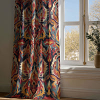 Full-length multicolor ikat curtain draping to a wooden floor