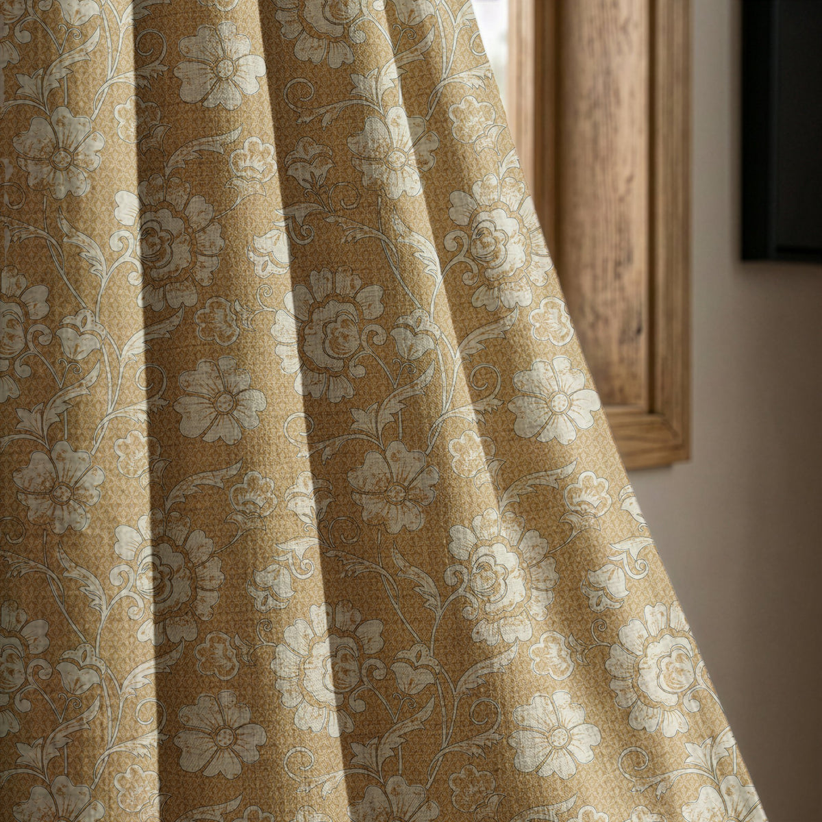Mustard floral damask curtain panel beside a rustic wooden window