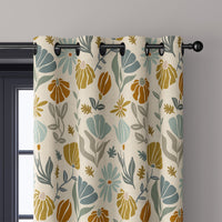 Close-up of mustard and sage boho botanical curtain grommets on a black rod