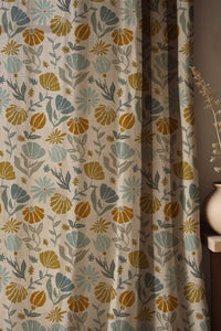 Soft folds of a mustard and sage botanical curtain