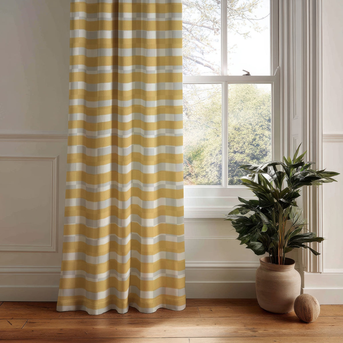 Mustard yellow check curtain panel hanging by a white window