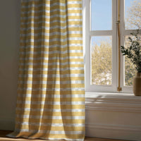 Full-length mustard yellow check curtain draping to a wooden floor