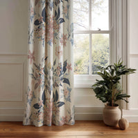 Navy and blush floral curtain panel hanging by a white window