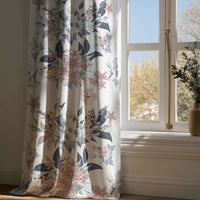 Full-length navy and blush floral curtain draping to a wooden floor