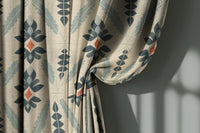 Navy folk diamond curtain gathered to one side