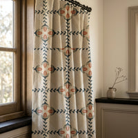 Navy folk lattice curtains in a warm living room