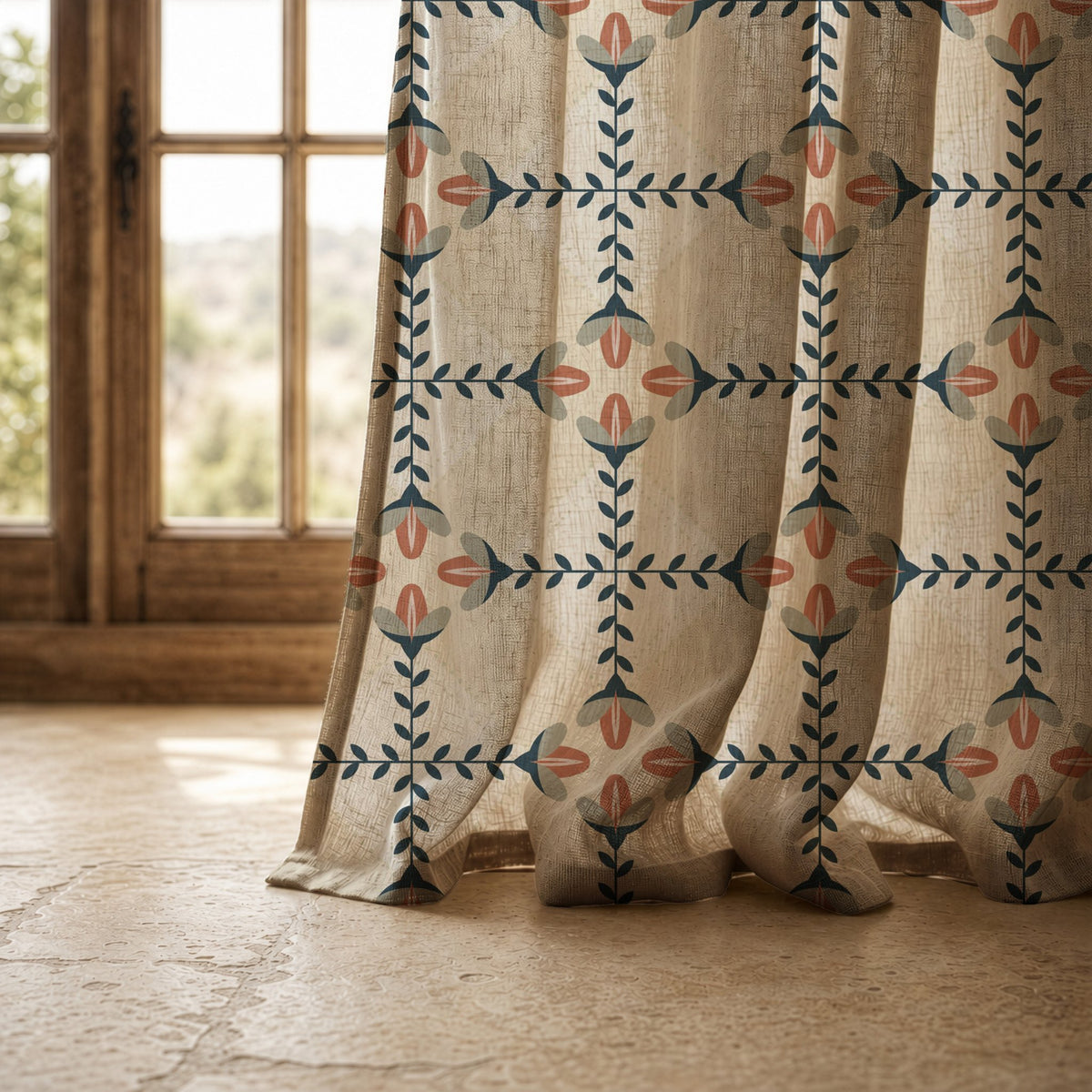 Hem of a navy folk lattice curtain resting on a stone floor
