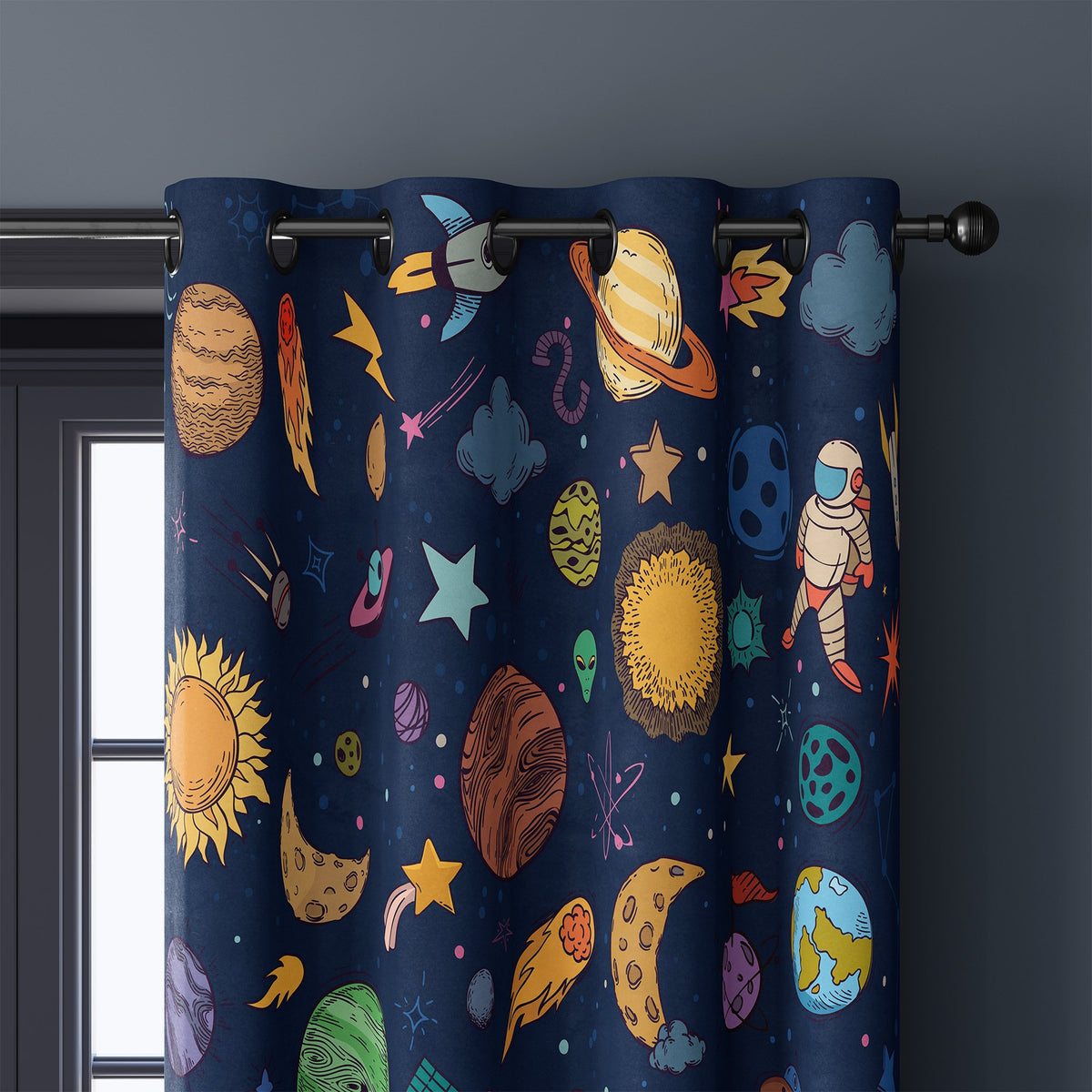 Close-up of navy outer space kids curtain grommets on a black rod