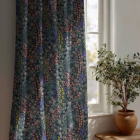 Navy wildflower meadow curtain beside a potted olive tree