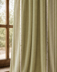 Pair of olive green stripe curtains at an arched window