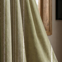 Olive green stripe curtain panel beside a rustic wooden window