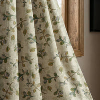 Olive leaf sprig curtain panel beside a rustic wooden window