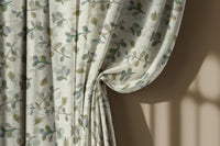 Olive leaf sprig curtain gathered to one side