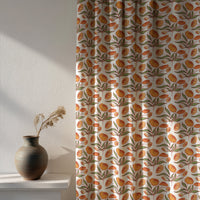 Soft daylight through a orange block print floral curtain