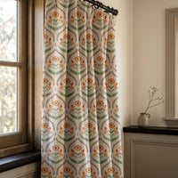 Orange ogee floral curtains in a warm living room
