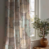 Pastel animal nursery curtain beside a potted olive tree