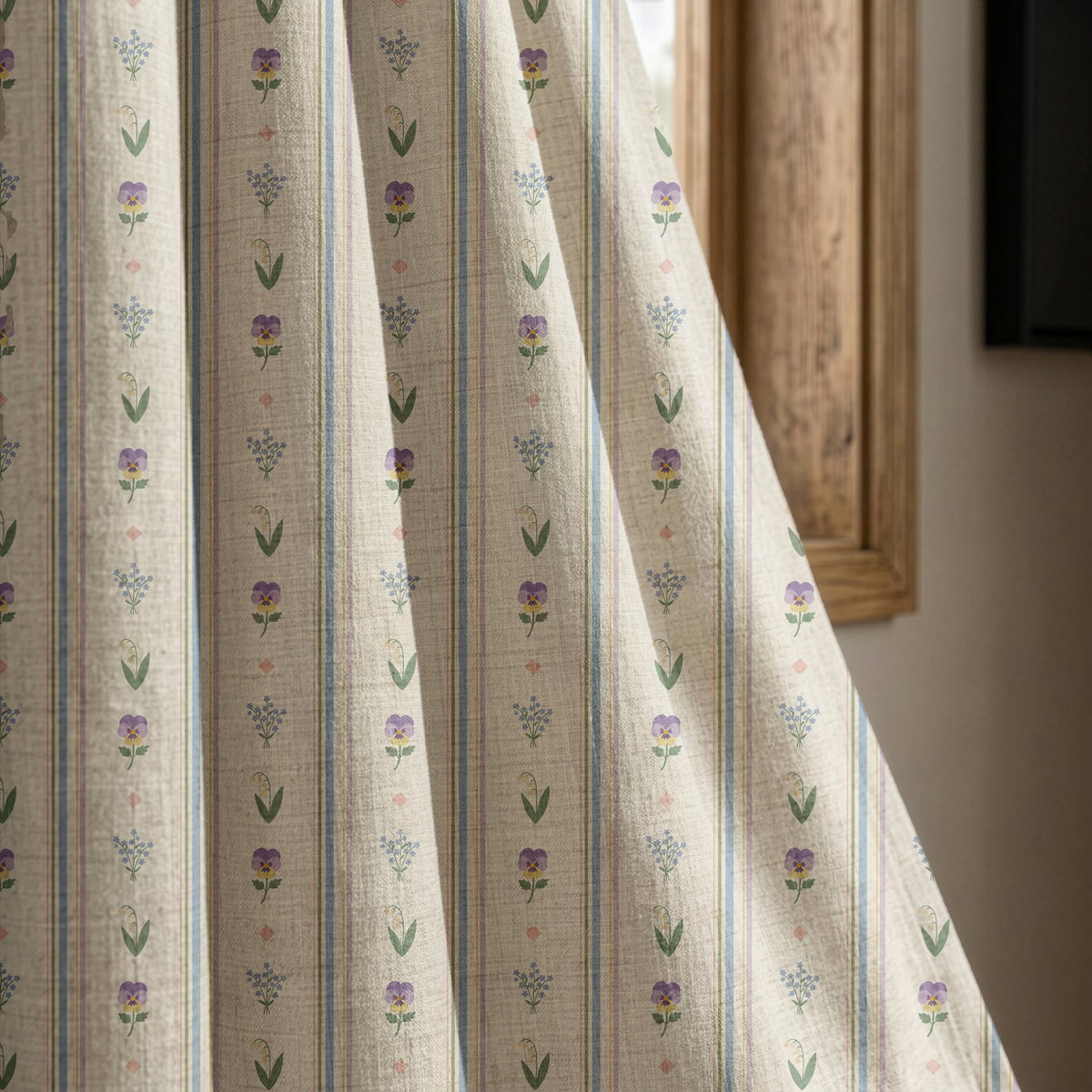 Pastel ditsy floral stripe curtain panel beside a rustic wooden window