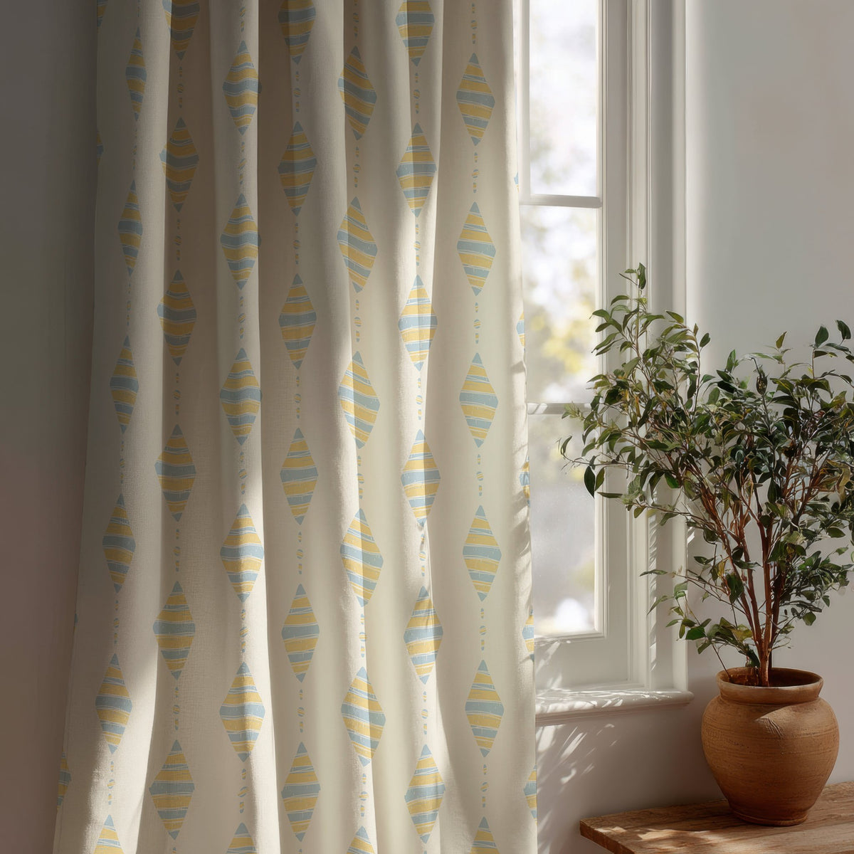 Pastel kite nursery curtain beside a potted olive tree