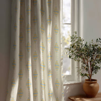 Pastel kite nursery curtain beside a potted olive tree