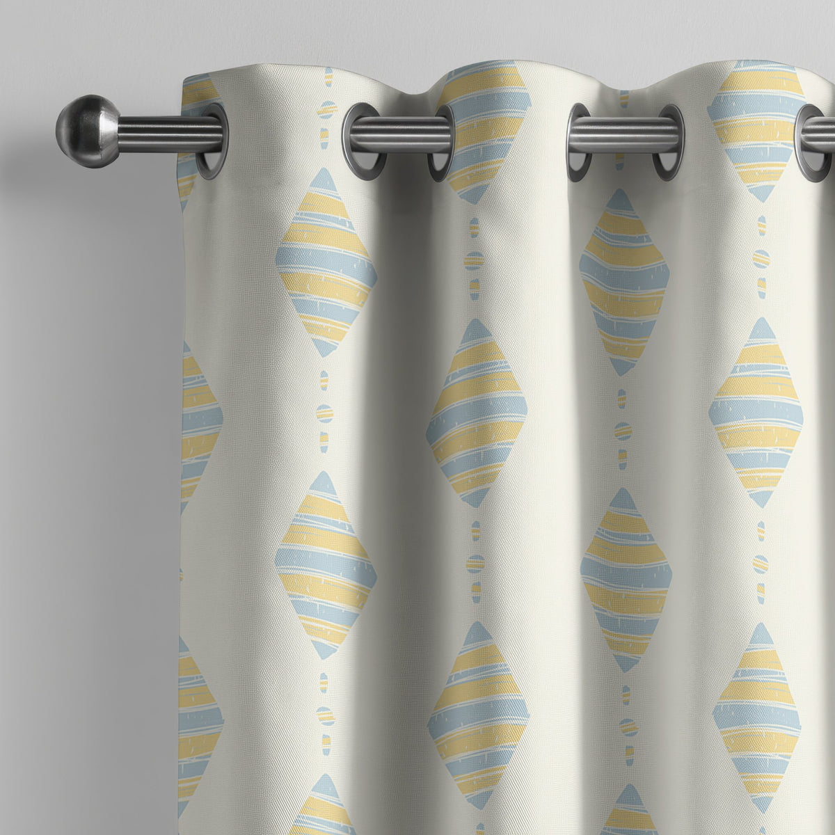 Pastel kite nursery curtain on a grommet rod, close-up of the print