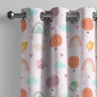 Pastel rainbow kids curtain on a grommet rod, close-up of the print