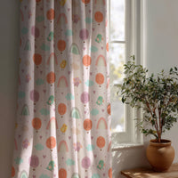 Pastel rainbow kids curtain beside a potted olive tree