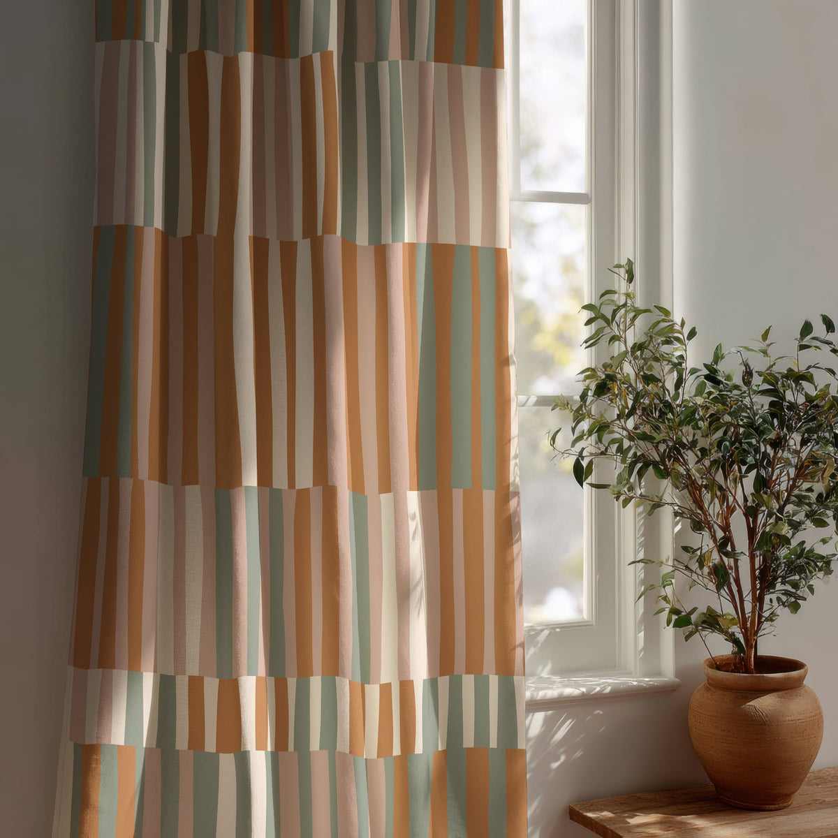 Patchwork color block curtain beside a potted olive tree