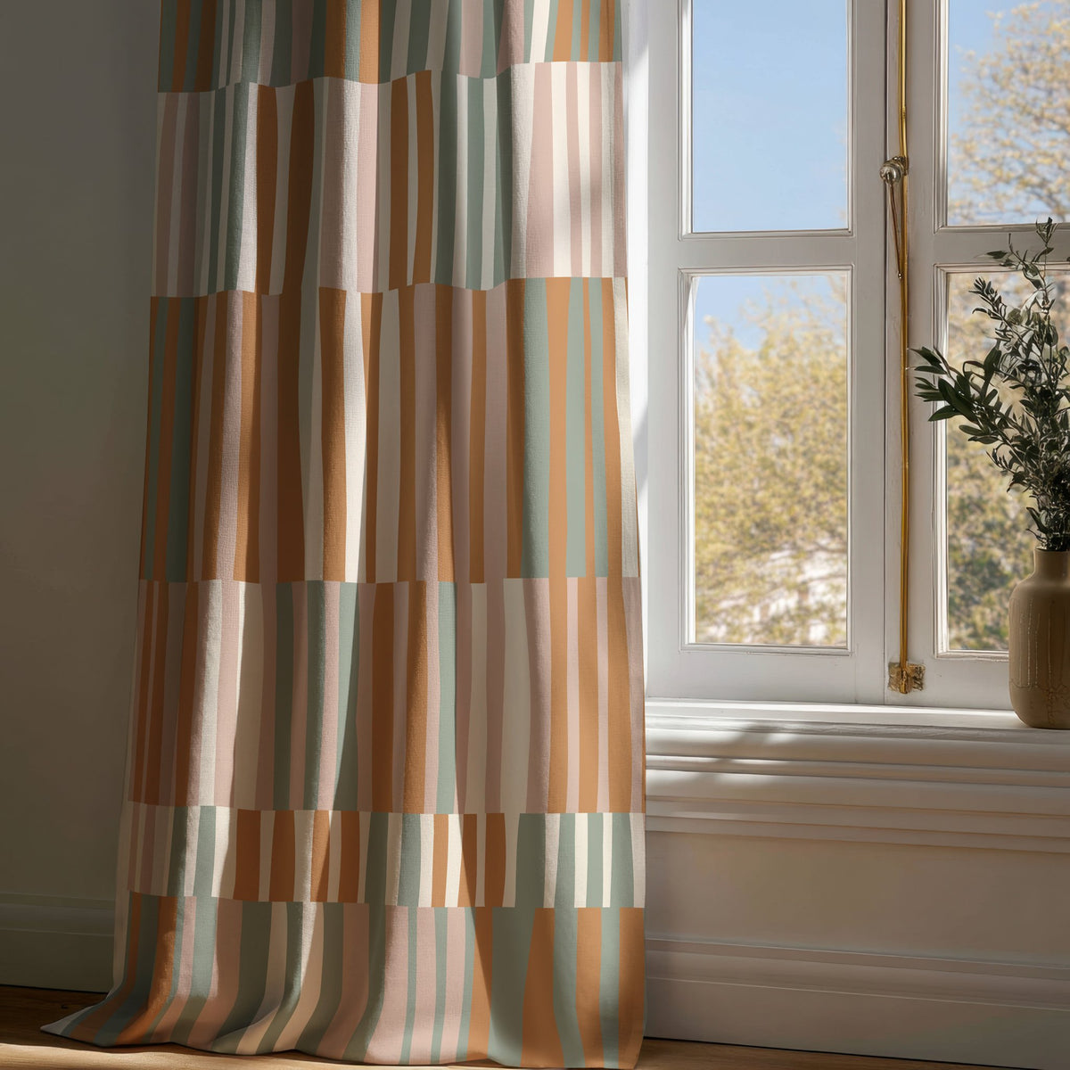 Full-length patchwork color block curtain draping to a wooden floor