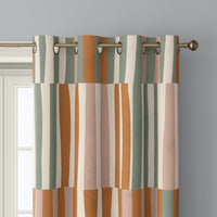 Close-up of patchwork color block curtain grommets on a black rod