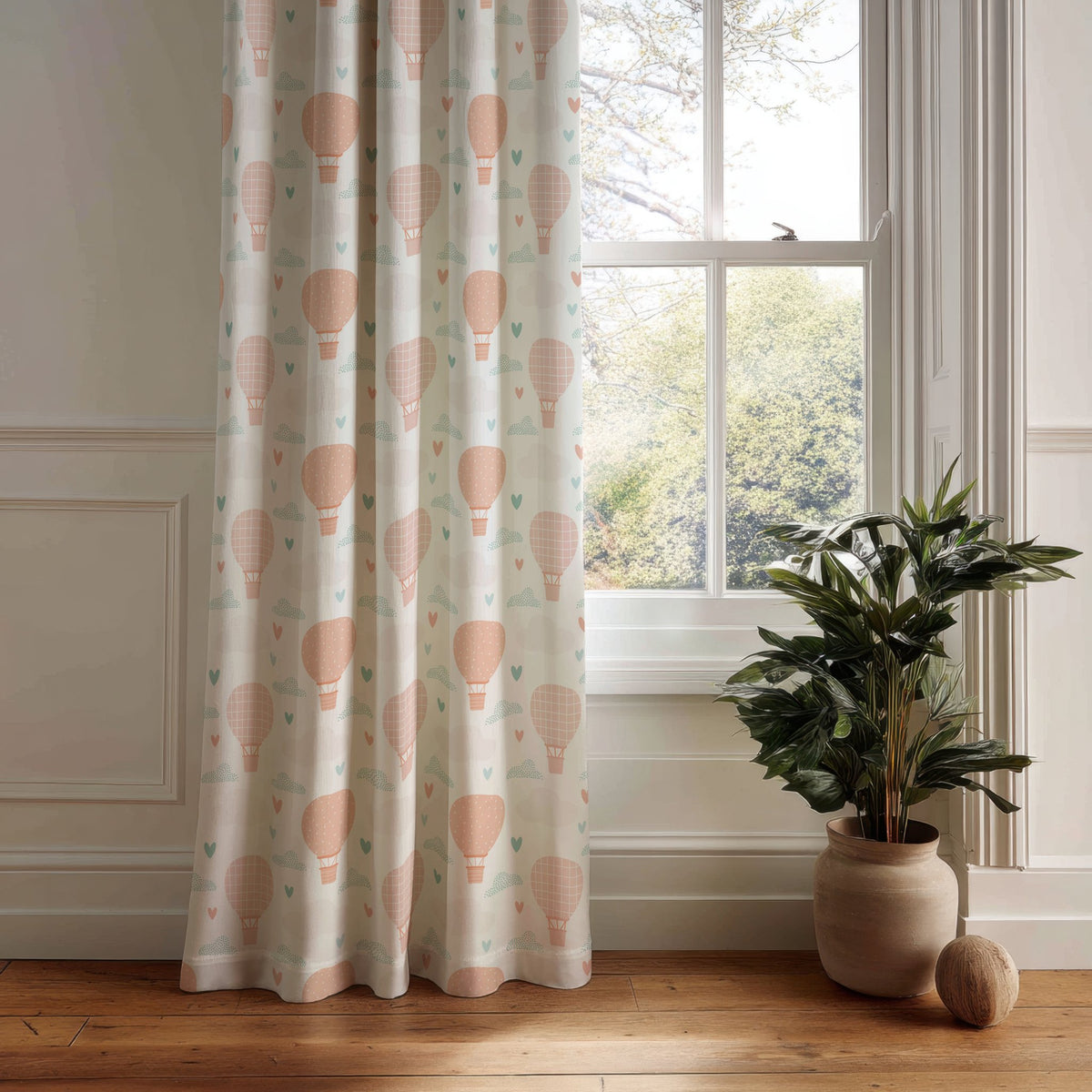 Peach hot air balloon nursery curtain panel hanging by a white window