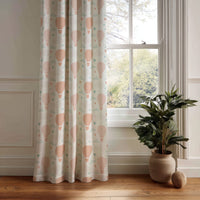 Peach hot air balloon nursery curtain panel hanging by a white window