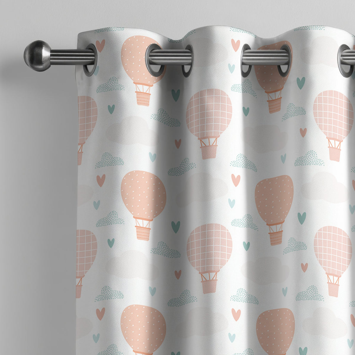 Peach hot air balloon nursery curtain on a grommet rod, close-up of the print