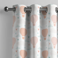 Peach hot air balloon nursery curtain on a grommet rod, close-up of the print