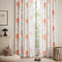 Peach hot air balloon nursery curtains in a child's bedroom
