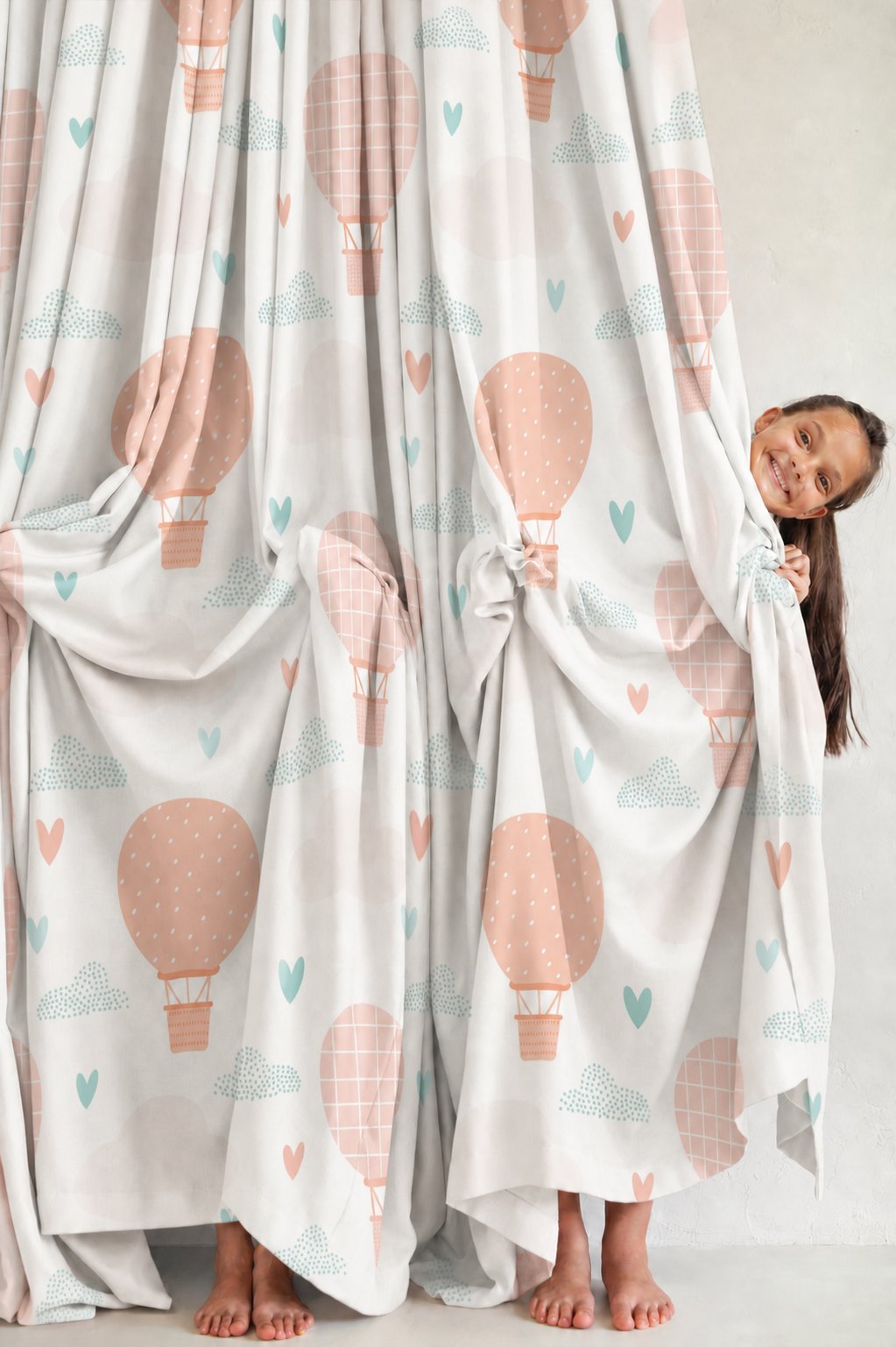 Pair of peach hot air balloon nursery curtains in a child's bedroom