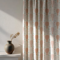 Soft daylight through a peach hot air balloon nursery curtain