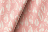Pink fern leaf nursery curtains framing a tall window