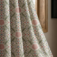 Pink folk medallion curtain panel beside a rustic wooden window