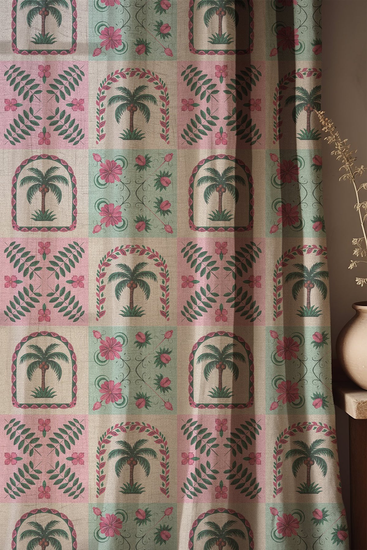 Soft folds of a pink and mint palm tile curtain
